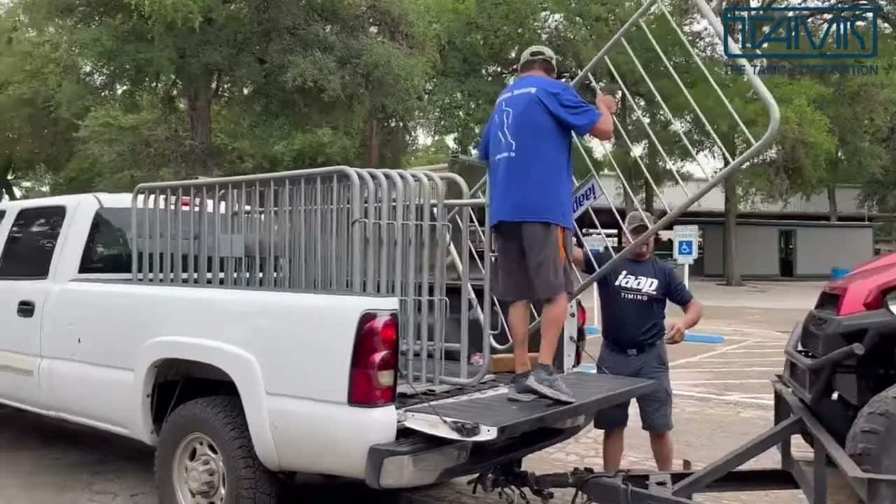 Two People unloading steel barricades